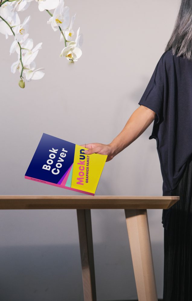 Book cover in hand mockup free