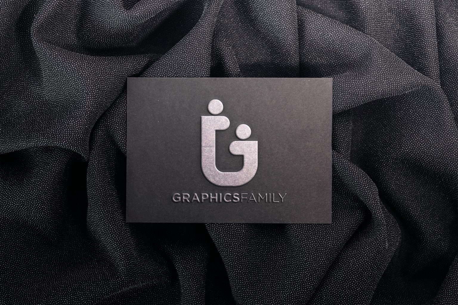 Embossed logo mockup on black paper GraphicsFamily